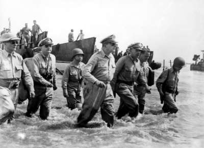 Gen. Douglas MacArthur wades ashore during initial landings at Leyte, Philippine Islands