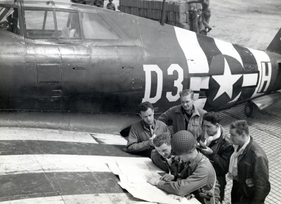 P-47 fighter-bomber pilots at a rough airstrip near St. Mere Eglise