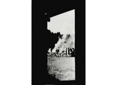 An image taken by Sonderkommando members in 1944 showing the burning of bodies outside the gas chamber.